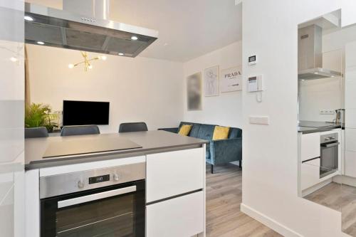 a kitchen with white cabinets and a counter top at Eindhoven City Suites Hoogstraat CC Modern 3P in Eindhoven