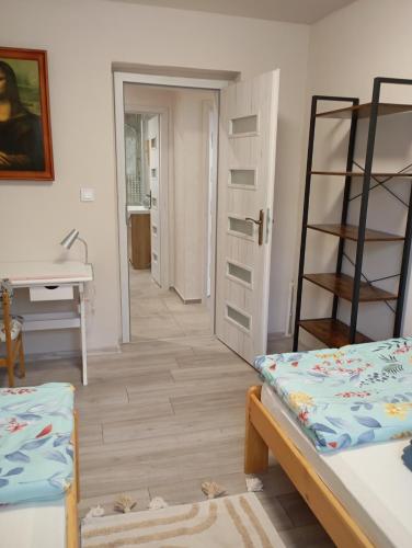 a room with a bed and a desk and a mirror at Dovolenkový dom Nika in Vinné