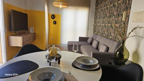 a living room with a table and a couch at Apartamento Yellow Garrucha in Garrucha