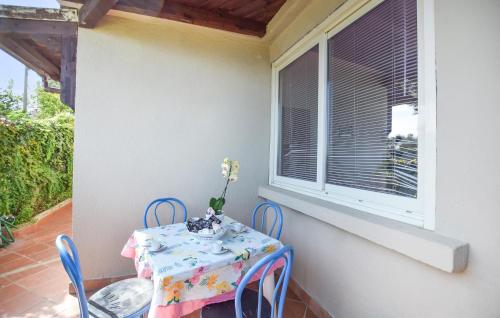 a table and chairs on a balcony with a window at 1 Bedroom Amazing Apartment In Staletti in Stalettì