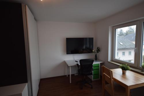 a room with a desk and a tv and a window at Nestwerk Clever R23-14 - Arbeiten, Erholen & Zentrumsnah in Biberach an der Riß