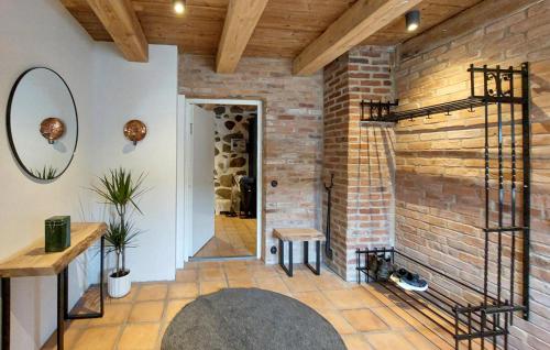 a room with a brick wall and a wine cellar at Lovely Home In Sallerup With Wifi in Hörby