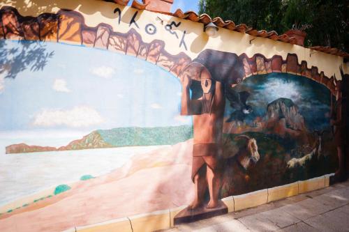 a mural on the side of a wall at Hotel Villa Belfiori in Torre Dei Corsari