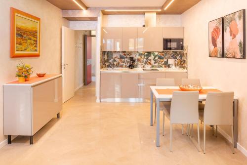 a kitchen and dining room with a table and chairs at Blue Lake Residence - Bardolino in Bardolino