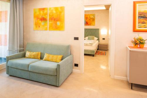 a living room with a couch and a bedroom at Blue Lake Residence - Bardolino in Bardolino