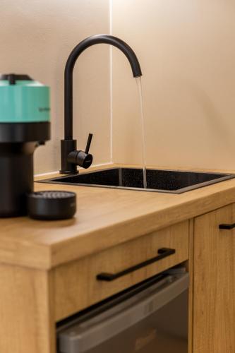 eine Küchenspüle mit Wasser aus einem Wasserhahn in der Unterkunft MKproperties in Volos