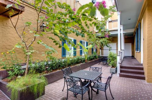 a patio with tables and chairs next to a building at Hotel Mazarin in New Orleans