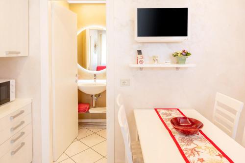 a bathroom with a table and a sink and a tv at Blue Lake Residence - Bardolino in Bardolino