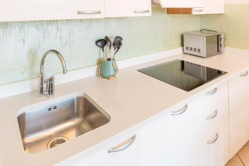 a kitchen with a sink and a microwave at Blue Lake Residence - Bardolino in Bardolino