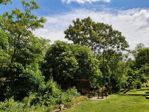 a picnic shelter in a park with trees and grass at House Mikin Dol in Draž