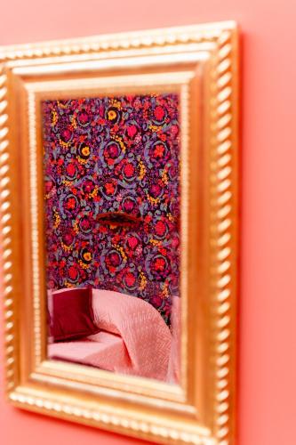 a picture of a mirror in a gold frame at Dea Estia Alloggio Turistico in Tuscania