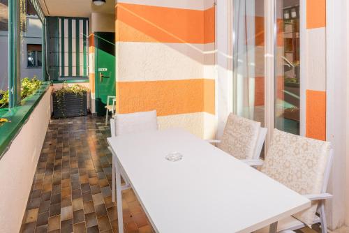 a white table and chairs in front of a building at Blue Lake Residence - Bardolino in Bardolino
