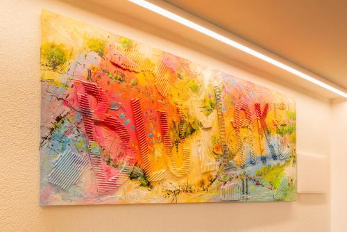a painting hanging on a wall at Blue Lake Residence - Bardolino in Bardolino
