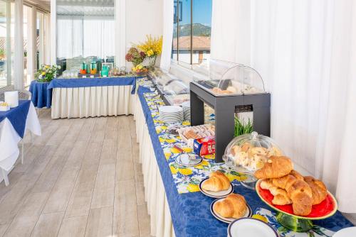 a buffet line with food on a blue table at Blue Lake Residence - Bardolino in Bardolino