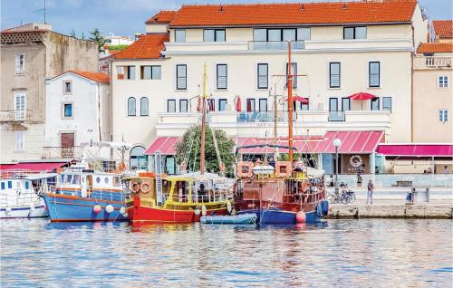 a group of boats docked in a harbor with buildings at Gorgeous Home In Zgaljici With Sauna in Žgaljić