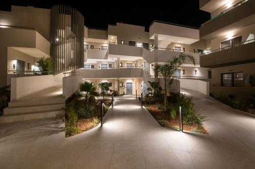 an apartment building at night with lights at Mare Village Hotel in Georgioupolis