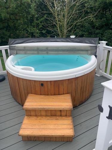 a jacuzzi tub sitting on a deck at Meadows 33 Hot tub - Southview Holiday Park in Skegness