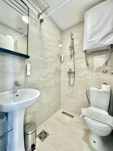 a bathroom with a toilet and a sink at Apartmani Terminal in Budva
