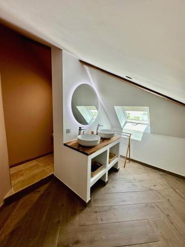 a bathroom with a sink and a mirror at Le Roquefeuil T4 Duplex St-Gilles in Saint-Paul