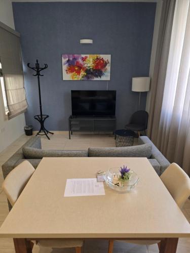 a living room with a table and a couch at D Townhouse Boutique Suites in Sliema