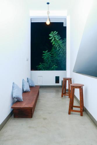 a living room with a couch and two stools at Kelly Ahangama in Ahangama