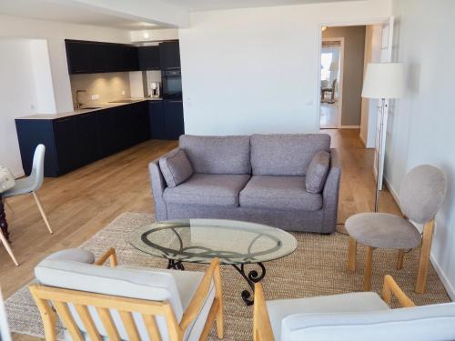 un salon avec un canapé et une table dans l'établissement Magnifique appartement T4 vue mer et parking privé, à Le Touquet-Paris-Plage