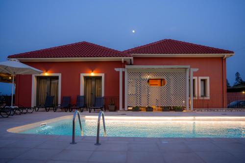 a house with a swimming pool in front of it at Crystal Palace - Vista in Skala Kefalonias