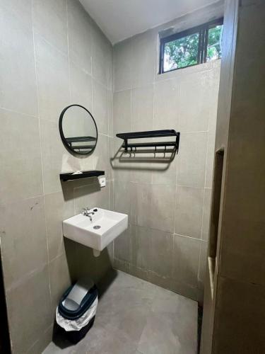 a bathroom with a sink and a mirror at Makarma Resort Lombok in Senggigi 