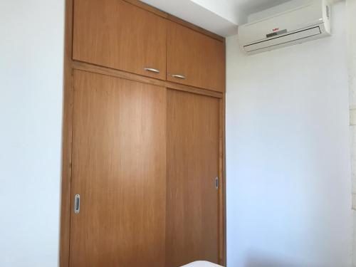 a closet with a wooden door in a room at San Rocco residence one bed apartments 1A2 4 in Isca sullo Ionio