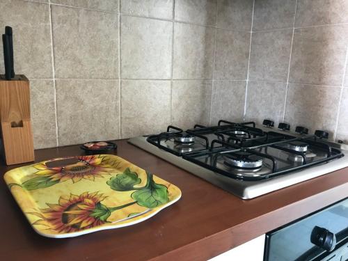 a kitchen counter with a stove and a plate on it at San Rocco residence one bed apartments 1A2 4 in Isca sullo Ionio