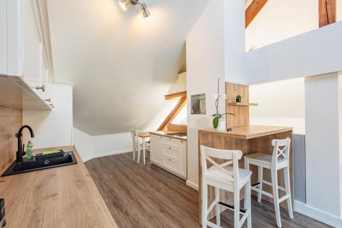 a kitchen with a table and chairs in a room at Die Sonne Nollingen in Nollingen