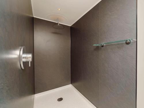 a shower with a glass door in a bathroom at Boutique Spa Lodge 1 in Birnam