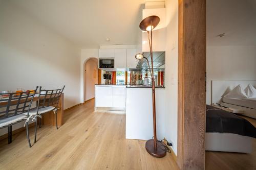 a living room with a kitchen and a dining room at Hotel Piz St. Moritz in St. Moritz