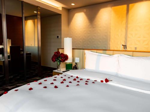 a bedroom with a white bed with red roses on it at Sofitel Mexico City Reforma in Mexico City