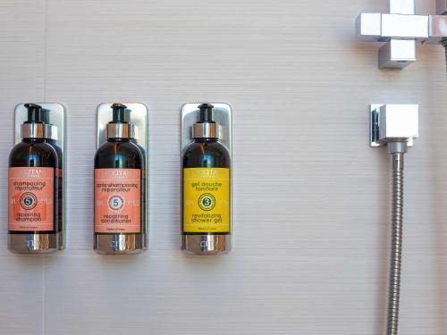 a group of three bottles of wine on a wall at Sofitel Mexico City Reforma in Mexico City