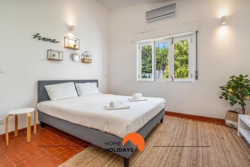 a bedroom with a bed and a window at #062 Villa Lemon 3 by Home Holidays in Albufeira