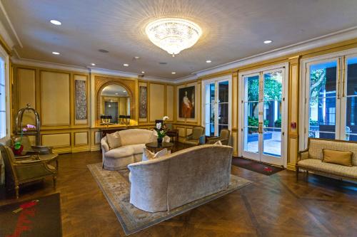 a living room with a couch and a table at Hotel Mazarin in New Orleans