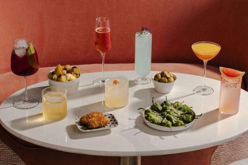 a white table with food and drinks on it at art'otel London Battersea Power Station, Powered by Radisson Hotels in London