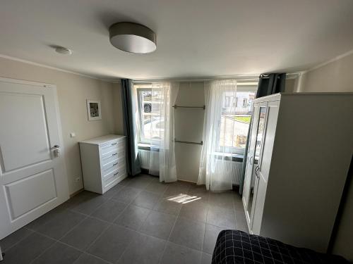 a room with a kitchen with a refrigerator and windows at Helfant Luxembourg Deluxe Double Room 2 in Palzem