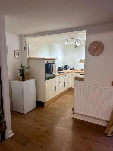 a kitchen with white cabinets and a counter top at Holly Tree Cottage in Glastonbury in Glastonbury