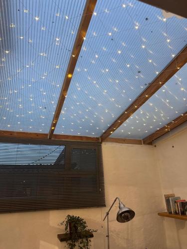 a room with a ceiling with lights on it at Holly Tree Cottage in Glastonbury in Glastonbury