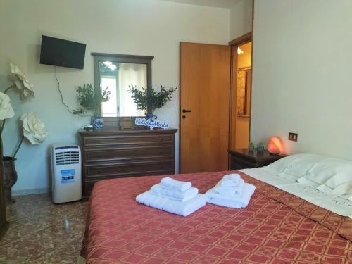 a bedroom with two towels on a bed at Zopito's House by Holiday World in Loreto Aprutino