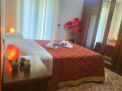 a bedroom with a bed and a table with a lamp at Zopito's House by Holiday World in Loreto Aprutino