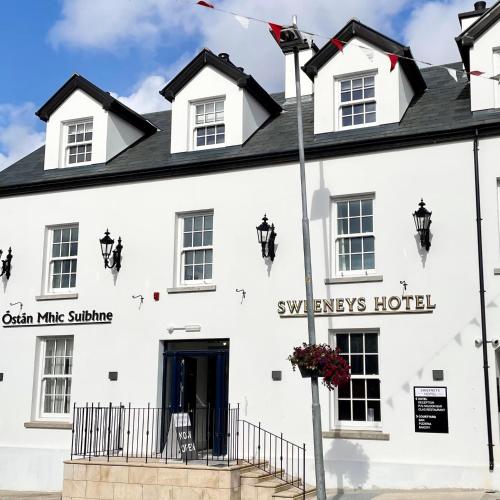 a white building with a sign that says swaps hotel at Sweeney's Hotel 2020 Limited in Dungloe