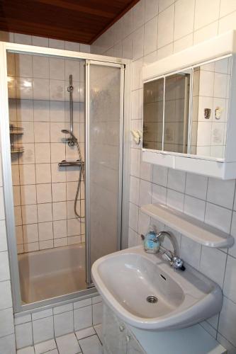 a bathroom with a sink and a shower at Seerobbe in Norddeich