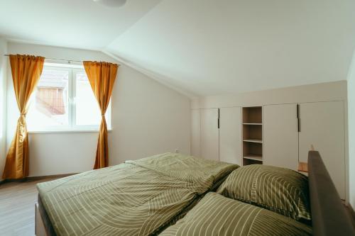 a bedroom with a bed and a window at Apartmán Nikola in Šaštín