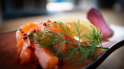 a plate of food with oranges and dunes on it at Hôtel Nell in Saint-Marcel