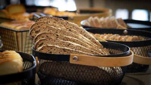 a group of baskets filled with bread and pastries at Hôtel Nell in Saint-Marcel