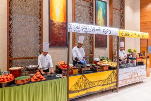 a group of chefs preparing food at a food stand at Pride Plaza Hotel, Kolkata in Kolkata