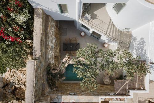 an overhead view of a building with plants and stairs at Porto Sereno Andros Suites in Andros